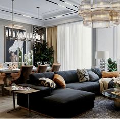 a living room filled with furniture and a chandelier hanging over the top of it