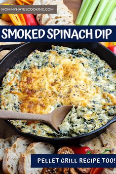 a skillet filled with baked spinach dip and sliced bread on the side next to vegetables