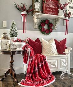 a living room decorated for christmas with red and white decor