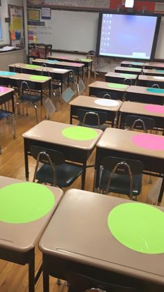 an empty classroom with desks and chairs covered in green and pink polka dot decals