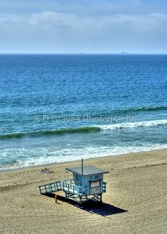 a lifeguard tower on the beach next to the ocean