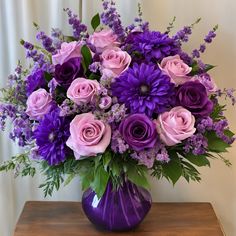 a purple vase filled with pink and purple flowers