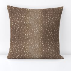 a brown pillow with white spots on it