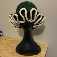 a crocheted hat on top of a mannequin head