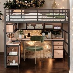 a bunk bed with a desk underneath it and christmas decorations on the wall behind it