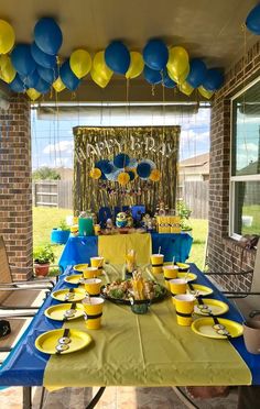 a table set up with yellow and blue plates