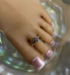 This toe ring features a black retro flower with a rope style band that adorns the toe. This toe ring is size adjustable and one size fits most. Comfortable and versatile, it will lend itself to casual or formal events. All items are made in a smoke free environment. *If there is any issue with your order, please let me know so that I can correct it. Thanks for visiting my shop!👣 Cheap Toe Ring Jewelry For Party, Cheap Toe Rings As Gifts, Cheap Silver Toe Rings For Anniversary, Cheap Elegant Open Ring Toe Rings, Cheap Silver Anniversary Toe Rings, Cheap Elegant Open Toe Rings, Affordable Silver Toe Rings, Cheap Toe Rings, Cheap Stackable Silver Toe Rings