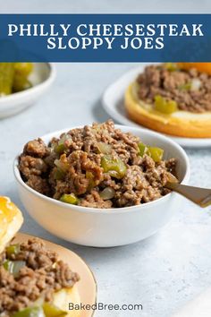 two bowls filled with cheesesteak sloppy joes on top of a white table