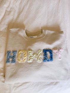 a t - shirt with the word hod on it is laying on a bed