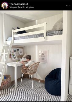 a young boy is sitting at his desk under the bunk bed in this white bedroom