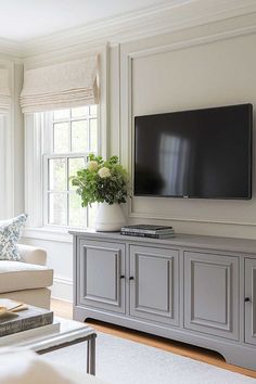 a large flat screen tv mounted to the side of a wall in a living room