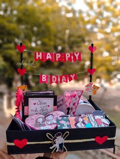 a birthday gift box filled with cards and other items