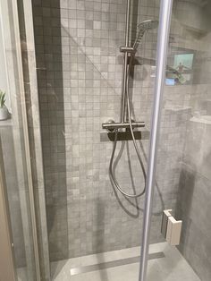 a walk in shower sitting inside of a bathroom