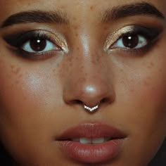 a close up of a woman's face with freckles on her nose