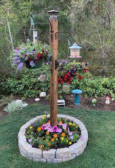 an outdoor garden with flowers and hanging planters