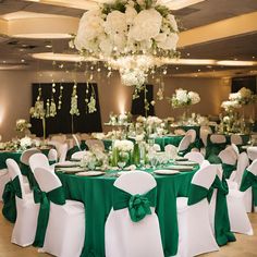 the tables are set up with green and white linens for an elegant wedding reception