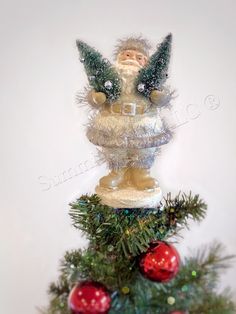 a small christmas tree with ornaments on top