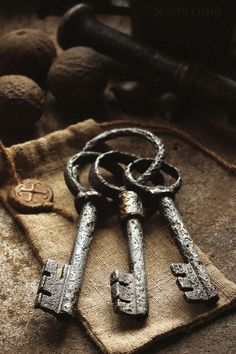 three old keys are sitting on a piece of cloth