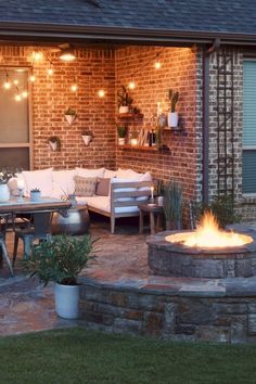 an outdoor patio with fire pit and seating