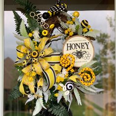 a yellow and black wreath is hanging on the front door