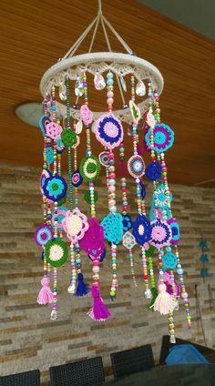 a chandelier made out of crochet and beads hanging from the ceiling