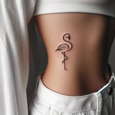 a woman's stomach with a flamingo tattoo on her lower back and side