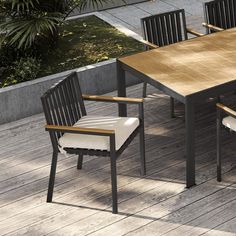 an outdoor table and chairs on a wooden deck