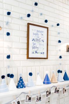 a white table topped with blue and white party hats