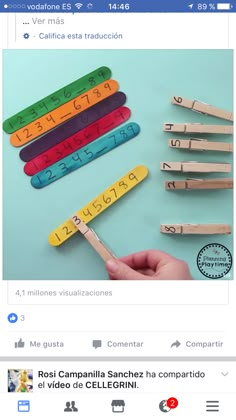 a person holding a wooden stick with numbers on it in front of a facebook page