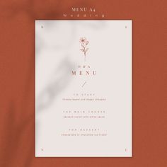 a menu card with a single flower on the front and bottom, in white ink