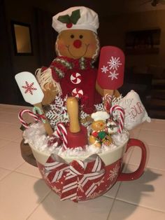 a cup filled with lots of christmas items