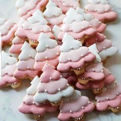 some pink and white decorated cookies on a table