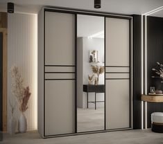 an open closet with mirrored doors and black trim on the door, in a modern style