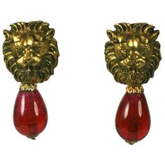 The most classic of earrings from Chanel with lions heads motifs . This is one of her favorite code motifs in textured and gilded bronze. Ruby Pate de verre pendant teardrops with clip back fittings. France circa 1960s. Unsigned. Excellent Condition Length 1.75" Width .75" Ruby Drop Earrings, Chanel Stud Earrings, Chanel Perfume Bottle, Lion Jewelry, Jewelry Editorial, Clothing Guide, Gold Chanel, Chanel Earrings, Classic Earrings