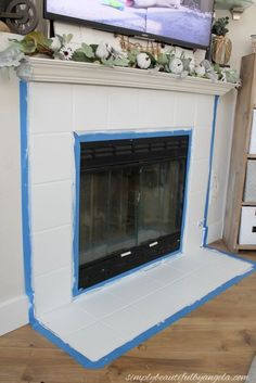 the fireplace is being painted white and blue