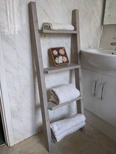 a bathroom with a ladder shelf next to a sink