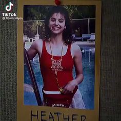 a photo of a woman wearing a red tank top and holding a tennis racquet