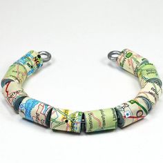 a bracelet made out of newspaper strips