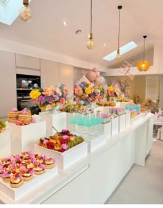 a table filled with lots of desserts on top of white trays next to each other