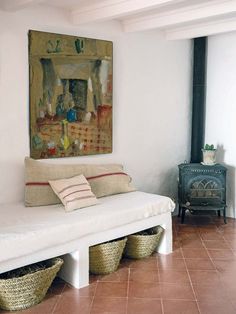 a living room with a couch and some baskets on the floor