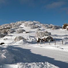 a snow covered mountain with houses on it