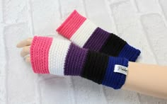 a hand is shown with colorful knitted gloves on it