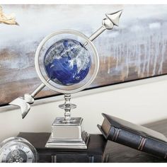 a desk with a globe and pen on it