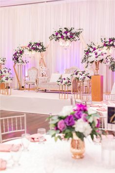 an elegant wedding setup with white and purple flowers