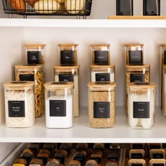 the shelves are full of spices and other items in glass containers, with labels on them