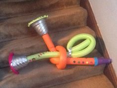 an assortment of toys sitting on the stairs