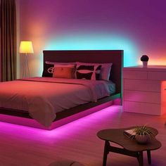 a bedroom with purple and blue lights on the wall above the bed, along with a coffee table