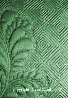 an image of a green quilted background