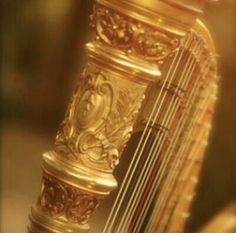 a golden instrument with ornate designs on it