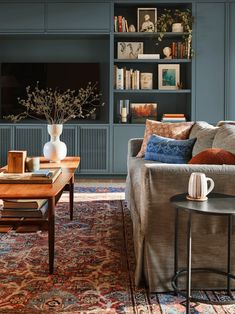 a living room filled with furniture and bookshelves